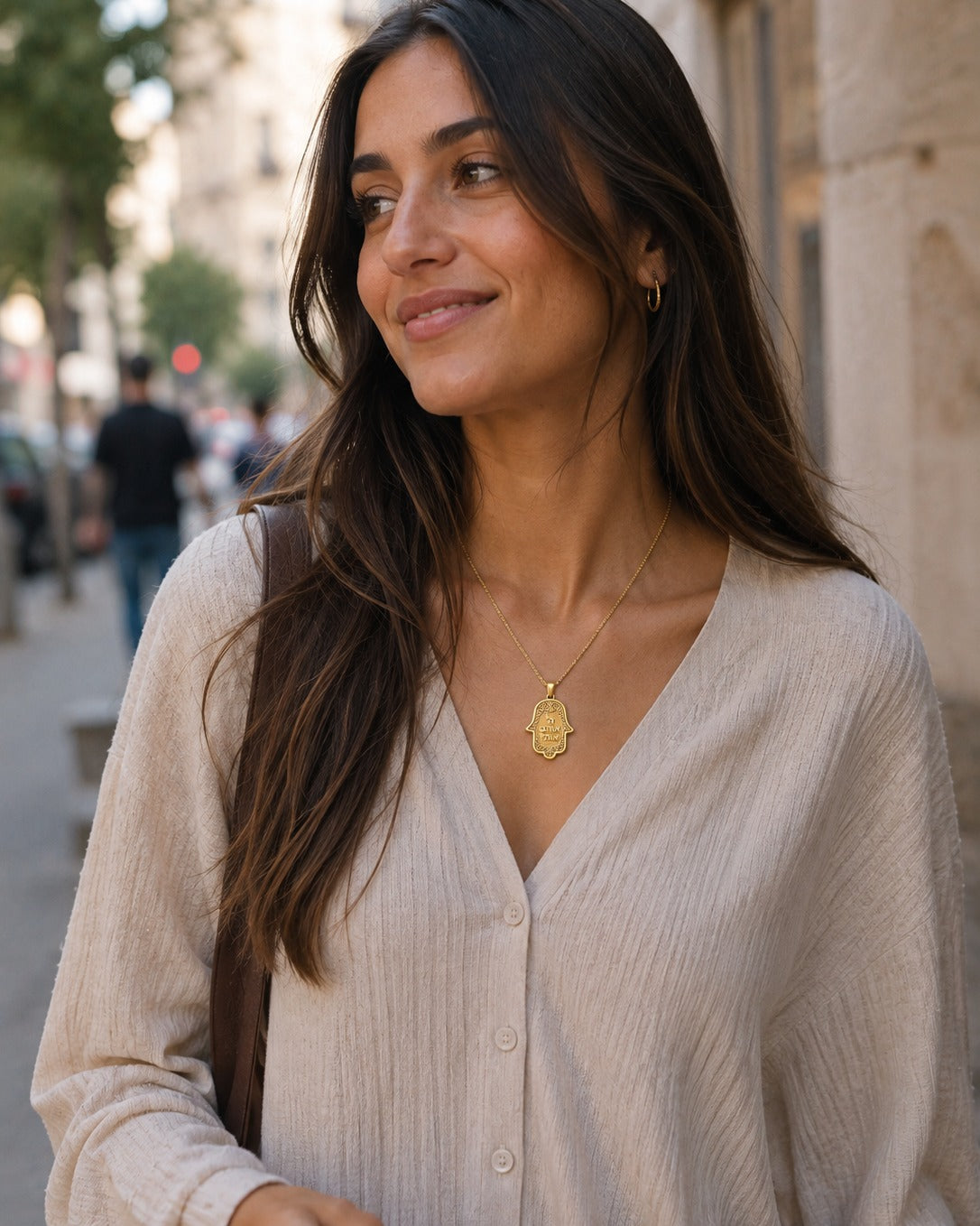 The Hamsa Pendant · Hebrew in Gold worn on a city street — Hashem Loves Me jewelry